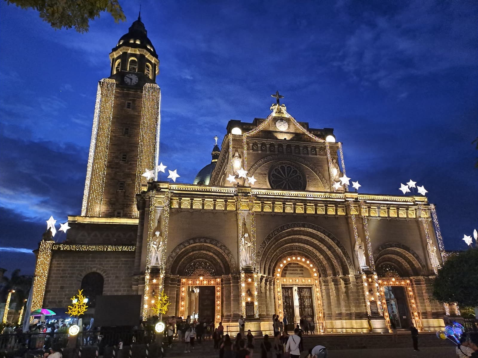 Manila Cathedral illuminated at dusk during Simbang Gabi celebrations