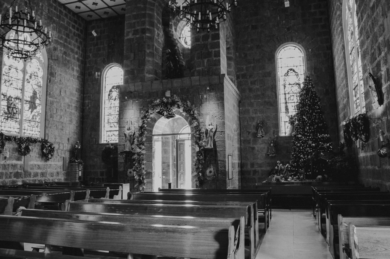 A candlelit church at night during Christmas Mass